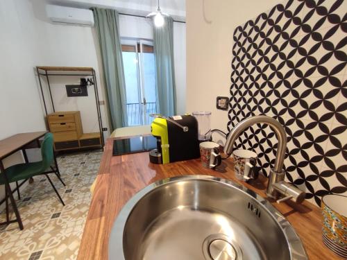 a kitchen with a stainless steel sink in a room at Edahouse in Salerno