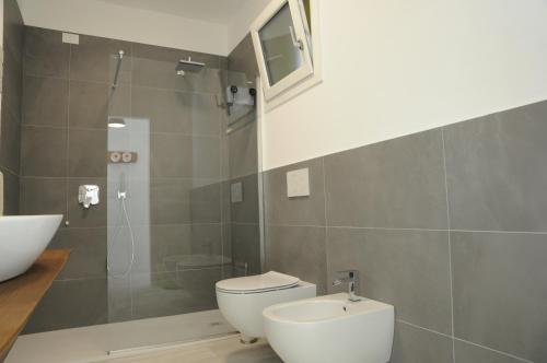a bathroom with a toilet and a sink and a shower at Casa Guarnati Lake View Apartments in Malcesine