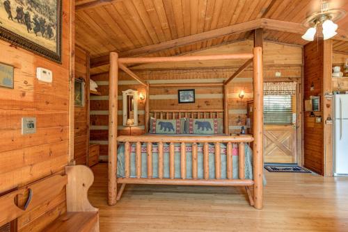 a bedroom with a bed in a log cabin at Rustic Charm in Gatlinburg