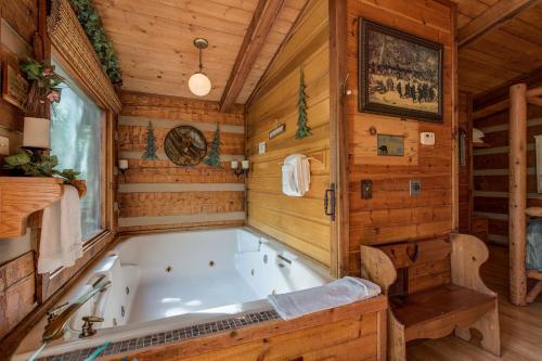 a bath tub in a room with wooden walls at Rustic Charm in Gatlinburg