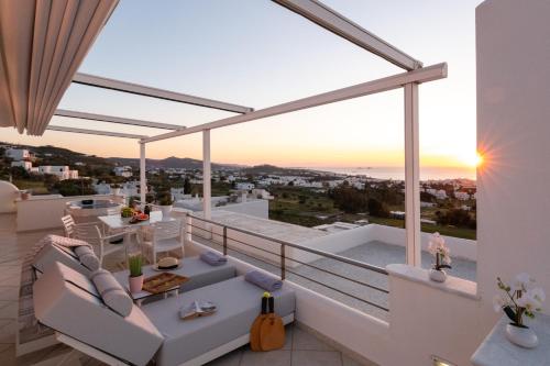 a villa with a view of the ocean from a balcony at Panos Luxury Suite in Parikia