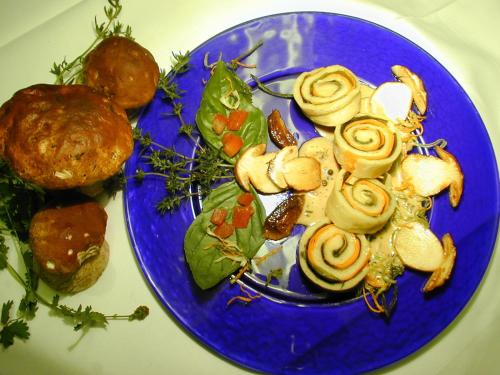 a blue plate of food with vegetables on a table at Kurhotel Würdinger Hof in Bad Füssing