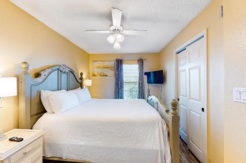 Un dormitorio con una cama y un ventilador de techo. en Islander Beach Resort unit 3009, en Fort Walton Beach