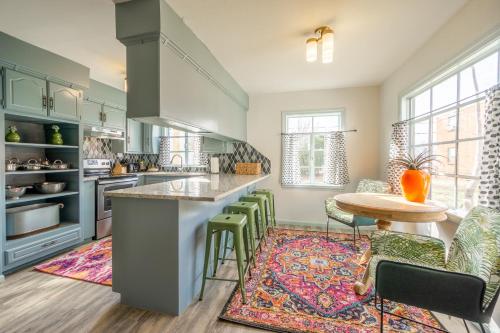 a kitchen with green cabinets and a table and chairs at Comfy Colonial - up to 15 ppl 5 mins to Plaza District or State Fair in Oklahoma City