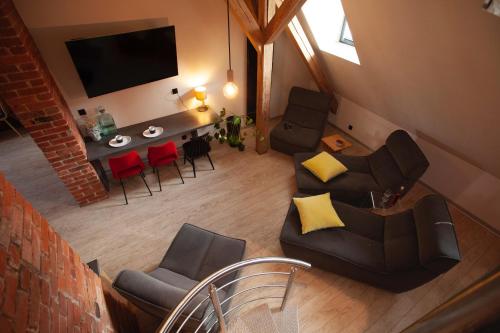 a living room with a couch and chairs and a table at Apartament "Przy Rynku" in Gliwice
