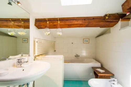 a bathroom with a tub and a sink and a toilet at Appartamento Borgo Apostoli in Florence