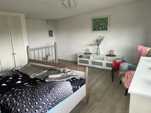 a bedroom with a bed and a table and chairs at Kellys SPA in Kdyně
