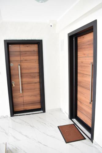 two wooden doors in a room with a tile floor at Skopje Kale Luxury Apartment in Skopje