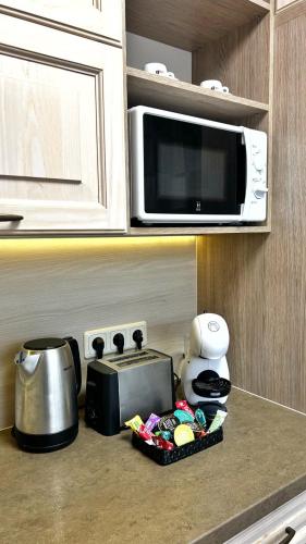 a kitchen counter with a microwave and a toaster at New Apartment with a View in the Town Center in Narva