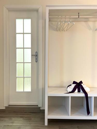 a white room with a window and a shelf with a bow at Il Ponte a Vapore Guest House in SantʼAnastasia