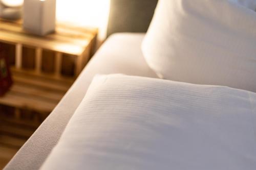 a close up of a bed in a room at Apartments an der Oper - Innenstadt - Zentral - Küche - Wifi - Powered by Ko-Living in Halle an der Saale