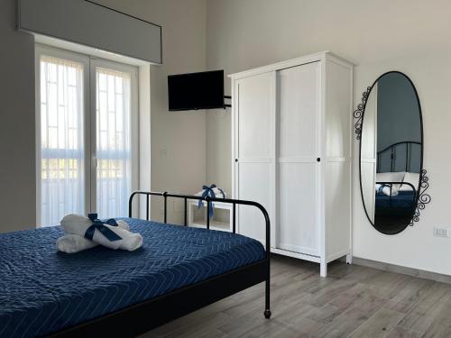 a bedroom with a bed and a mirror at Il Ponte a Vapore Guest House in SantʼAnastasia