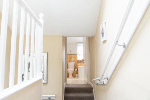 a staircase in a house with a toilet at 3 Private bedrooms attached to hosts home Free parking in Perth