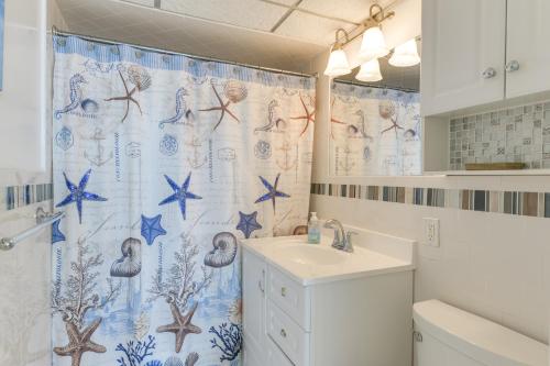 a bathroom with a shower curtain and a sink at Stunning Beachfront Condo with Panoramic Ocean View in Wildwood Crest