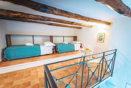 two beds in a room with wooden ceilings at MARE LUNA in Maiori