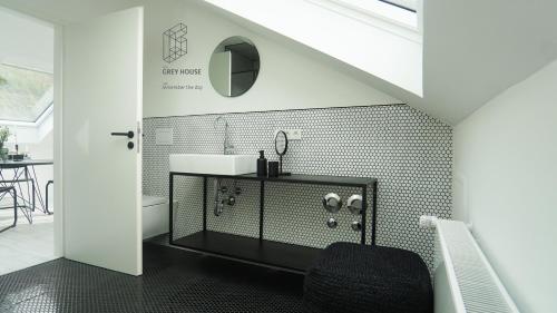 a bathroom with a sink and a toilet and a mirror at The Grey House in Kröv