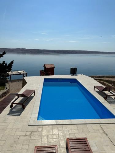 a swimming pool with a view of the water at Family Villa Tiffany&more in Barić Draga
