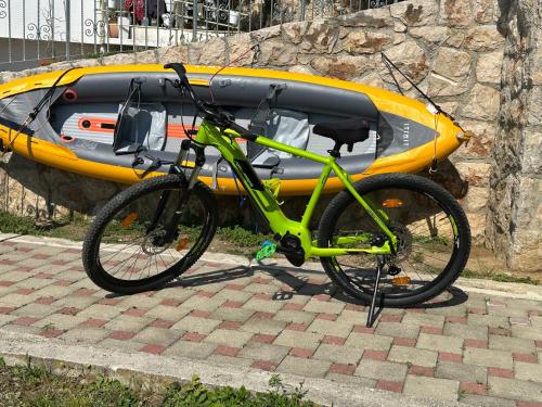 a green bike parked next to a yellow kayak at Family Villa Tiffany&more in Barić Draga