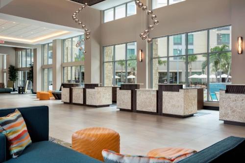 a lobby of a hotel with tables and chairs at SpringHill Suites by Marriott Orlando Theme Parks Lake Buena Vista in Orlando