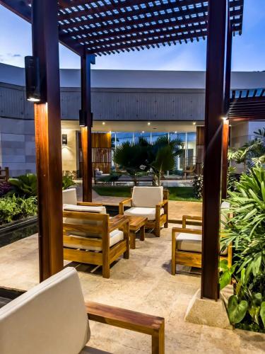 a group of chairs and tables on a patio at Eurobuilding Hotel & Suites Lecheria in El Morro de Barcelona