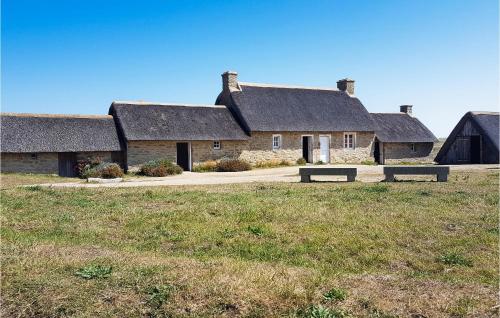 a group of stone buildings with roofs at Nice Home In Kerlouan With Wifi in Kerlouan