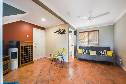 a living room with a couch and a table at 5 Brolga Place Peregian Beach in Peregian Beach