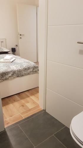 a bedroom with a bed and a shower and a toilet at KaLea Pula Center in Pula