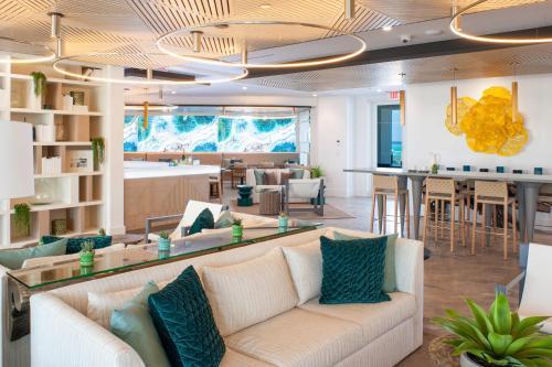 a living room with a couch and a bar at Club Suites at Rum Point in Driftwood Village