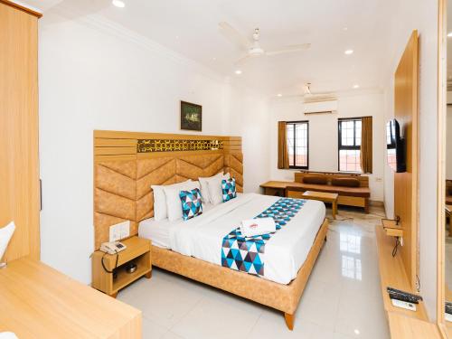 a bedroom with a large bed in a room at Hotel Galaxy Opp Surat Railway Station in Surat