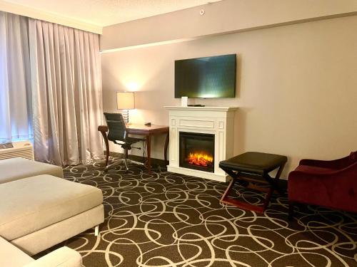 a hotel room with a fireplace and a living room at Park Manor Hotel in Clifton Park