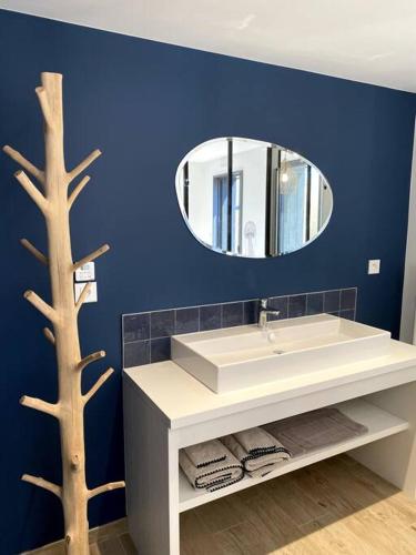 une salle de bain avec un lavabo blanc et un miroir dans l'établissement La Cabane des Pêcheurs, à Quiberon