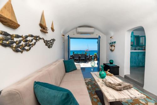 a living room with a couch and a table at Serenity Blue (Cave house) in Akrotiri