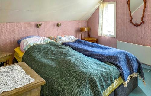 a bedroom with a bed with a blue blanket on it at 3 Bedroom Nice Home In Valldal in Valldal