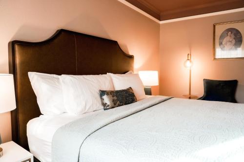 a bedroom with a large bed with white pillows at Columbia Gorge Hotel & Spa in Hood River
