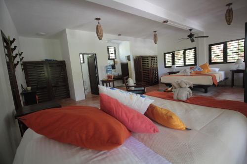 a bedroom with two beds with colorful pillows at Sol Caribe in Punta Allen
