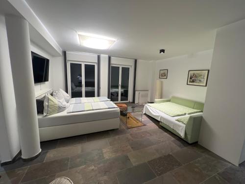 a living room with a bed and a couch at Appartment in Kammerl in Schörfling