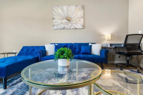 a living room with a blue couch and a glass table at Luxury 3 Bedroom/2 Bathroom Condo in Melbourne FL with Pool, Gym and Laundry in Melbourne
