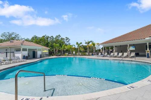a swimming pool at a resort with chairs at Luxury 3 Bedroom/2 Bathroom Condo in Melbourne FL with Pool, Gym and Laundry in Melbourne