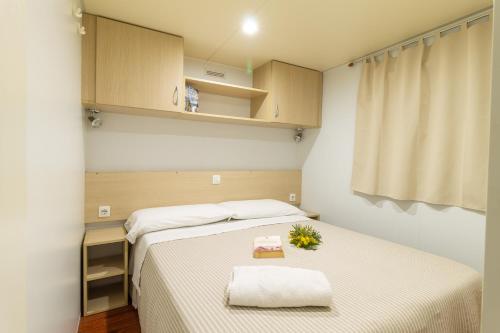a small room with a bed with white sheets at Agriturismo Il Gelsomino Ritrovato in Milazzo