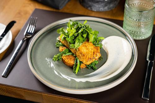 a plate of food with a salad on a table at Basel Marriott Hotel in Basel