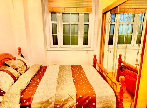 a bedroom with a bed and two windows at Tower Bridge! Immaculate One Bed in London