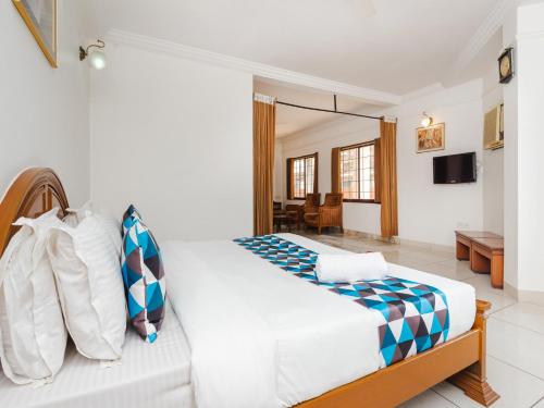 a bedroom with a bed and a living room at Hotel Galaxy Opp Surat Railway Station in Surat