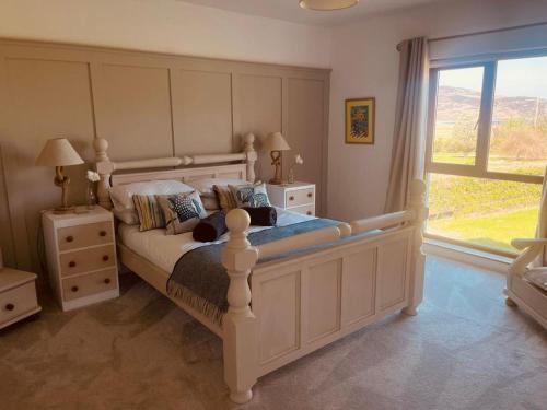 Un dormitorio con una cama grande y una ventana en Wild Atlantic Lodge, en Dunfanaghy