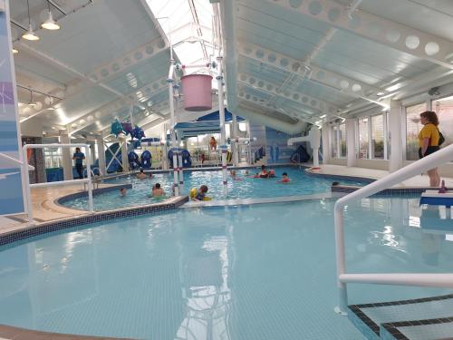 a large indoor swimming pool with people in it at Setons Getaway in Port Seton