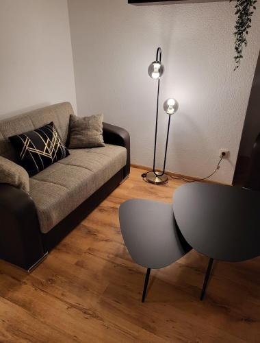 a living room with a couch and a table at Ferienwohnung am Bodensee in Tettnang