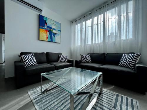 sala de estar con sofá y mesa de centro de cristal en Signature Point Bella Vista, Sea View 2 BR en Panamá