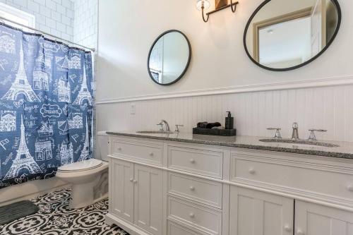 a bathroom with a sink and a toilet and a mirror at La Belle Luxe 3qnbed, walk to street car! in New Orleans