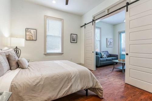 a bedroom with a bed and a living room at La Belle Luxe 3qnbed, walk to street car! in New Orleans