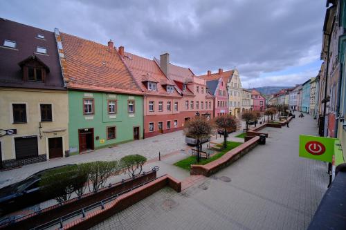 a city street with colorful buildings in a town at Urania KOWARY Apartamenty in Kowary