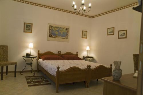 a bedroom with a bed and two tables and two lamps at La Meridiana Affittacamere in Colorno